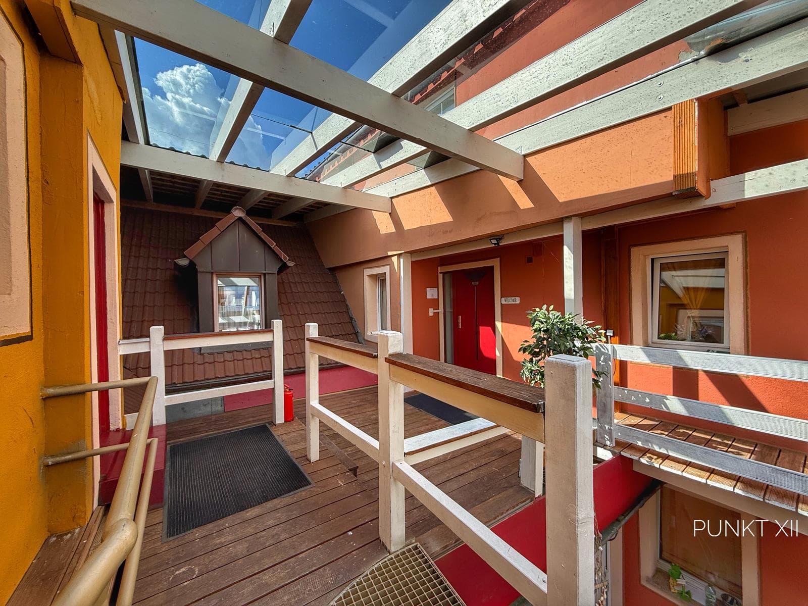 First-floor courtyard walkway with glass roof – access to apartments W2, W3 and W4