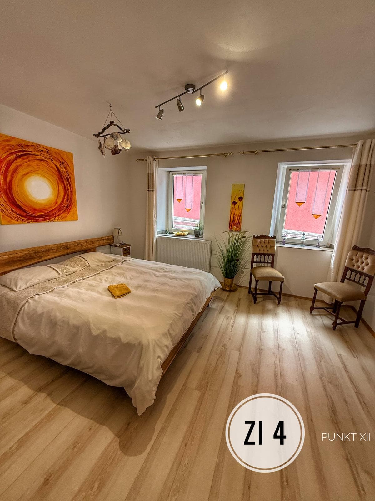 Room 4 with double bed, sun painting and two windows