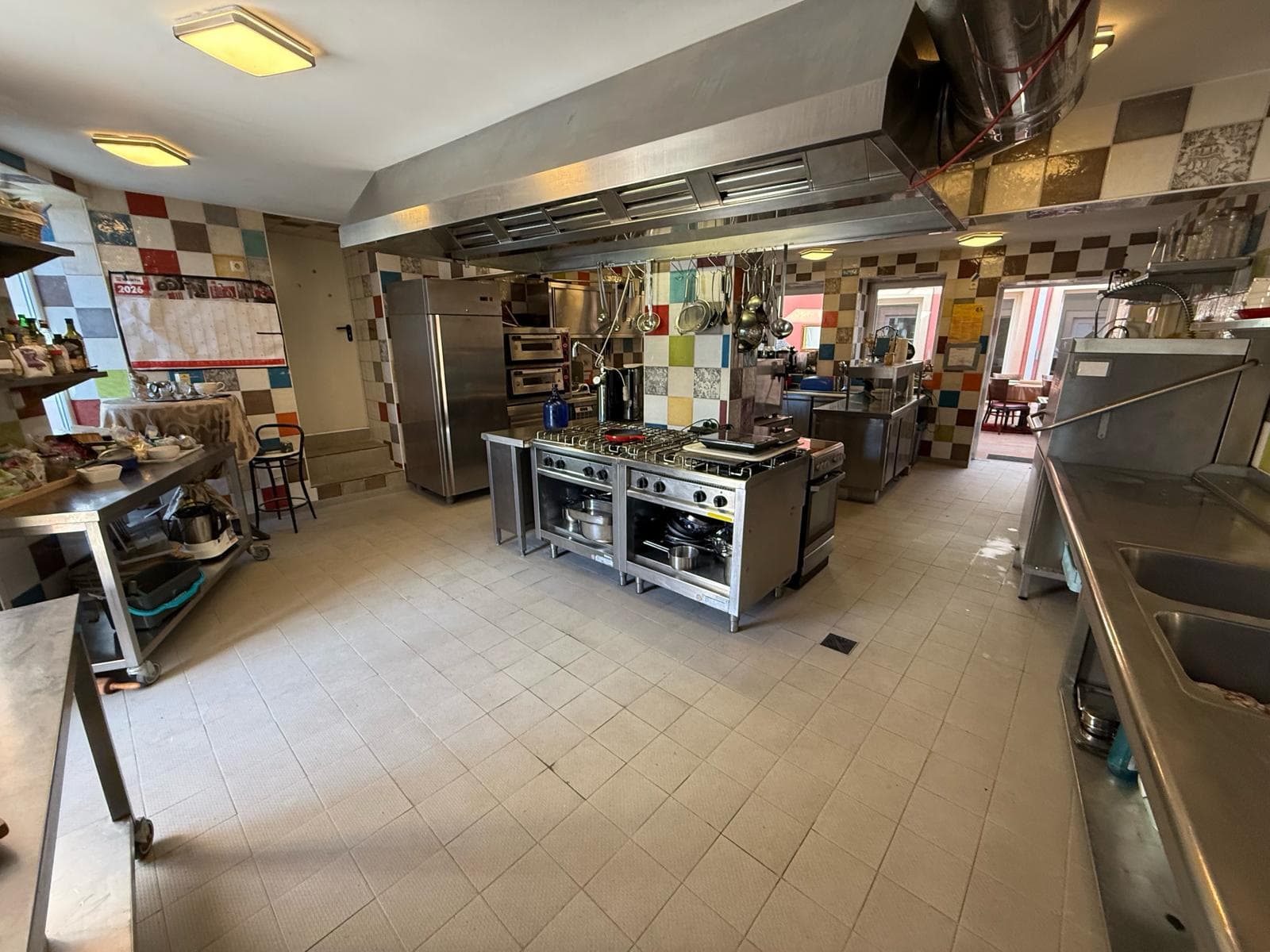Panorama of the large communal kitchen at Punkt XII with colourful tiles